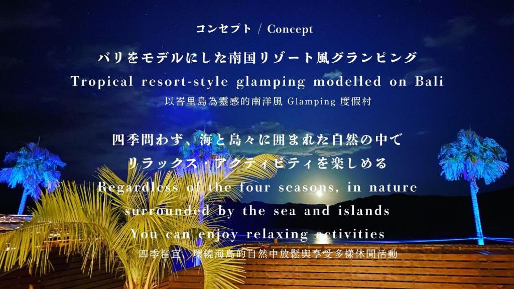 a sign with a palm tree at night at Glamping village Seagrand in Matsuura