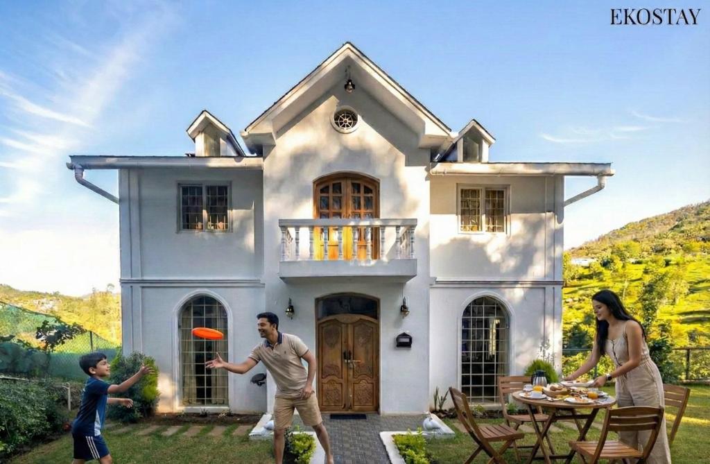 a family playing frisbee in front of a house at EKOSTAY - Winterfell Chalet Villa in Coonoor