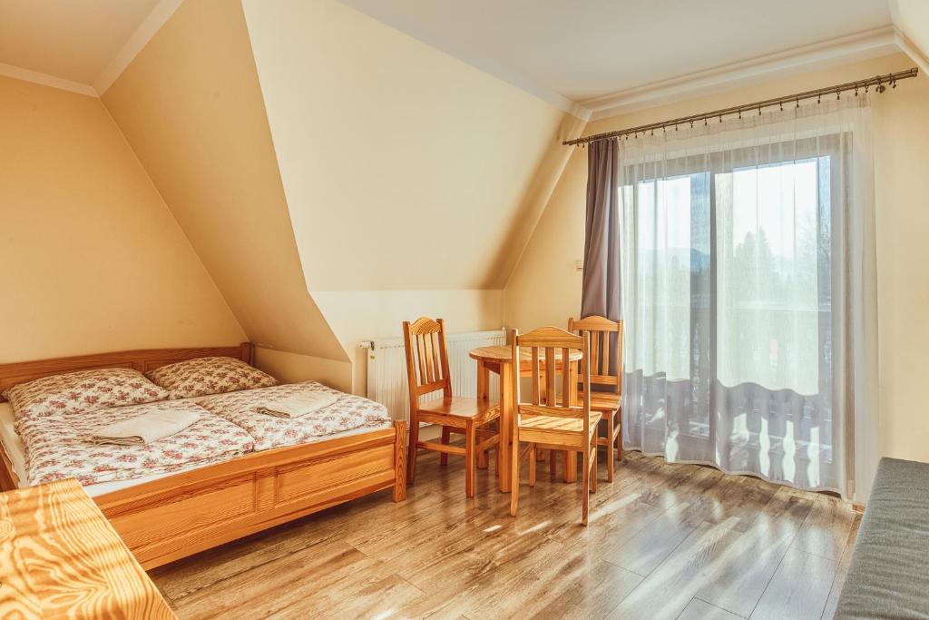 En eller flere senge i et værelse på Apartament II Chochołów 162c