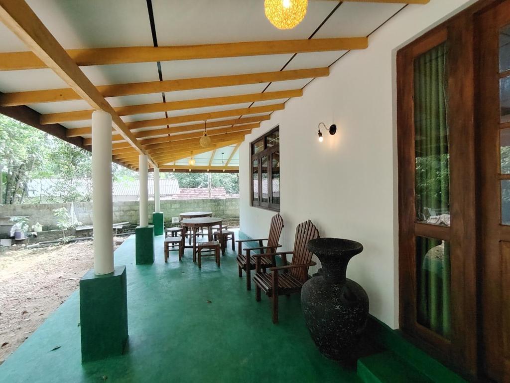 a room with chairs and tables and a wooden ceiling at Villa Hide Out in Busse