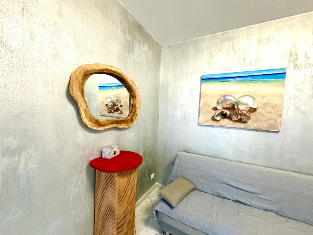 a bedroom with a bed and a picture of the beach at AppArt 24 city center parking and Sea Design district in Lignano Sabbiadoro