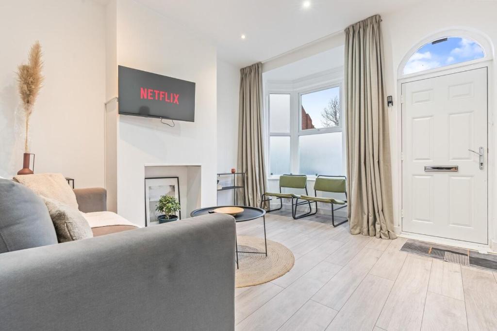 a living room with a couch and a tv at 3BR Sheffield Home - Contractor Friendly with WiFi in Sheffield