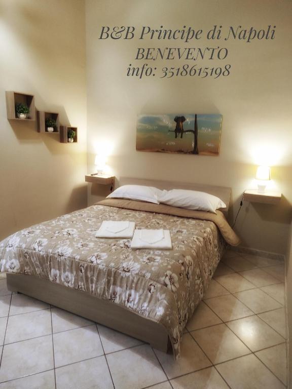 a bedroom with a bed with two towels on it at Il Principe di Napoli in Benevento