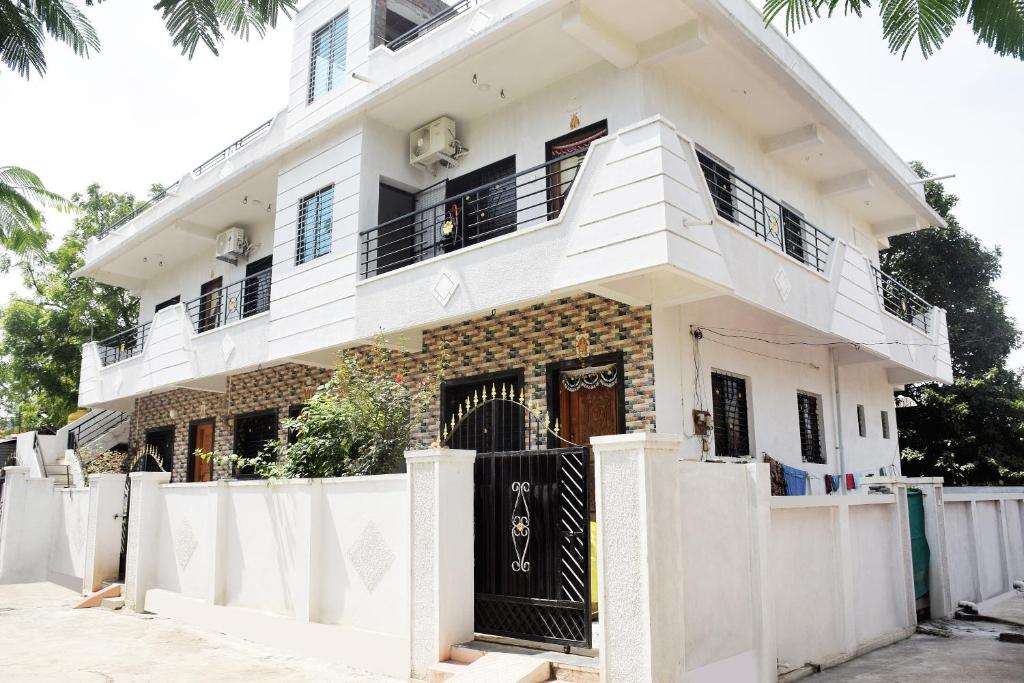 a house under construction with a white fence at Daneshwari Bhakt Niwas in Akalkot