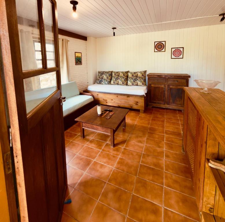 a living room with a couch and a table at Cabana Rosa na mata in Imbituba