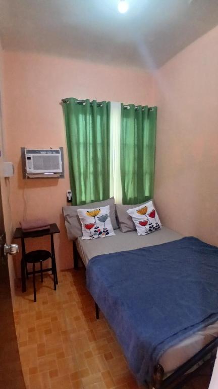 En eller flere senge i et værelse på Mel's Place Batangas City Unit 1 Two-Bedroom House w Free Parking, WIFI 4 adults & kids