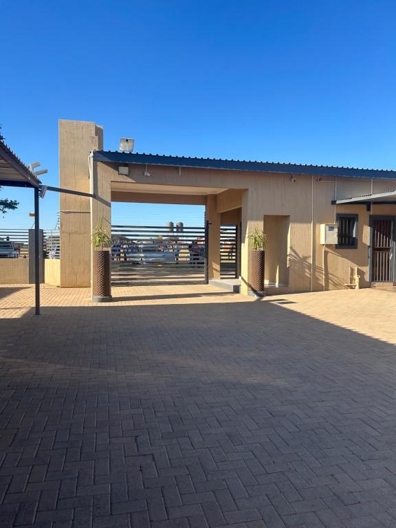 an empty parking lot in front of a building at Tshiamo Estate in Kuruman