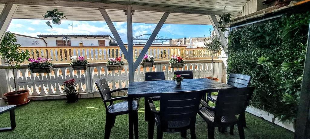 a table and chairs on a patio with a balcony at La Dimora del Colle in Palo del Colle