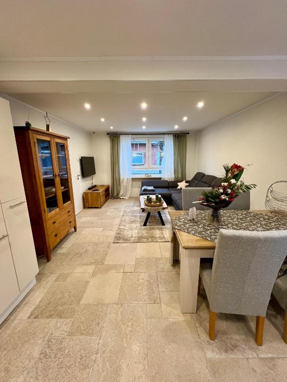 a living room with a couch and a table at Ferienwohnung auf dem Berg in Bad Bentheim