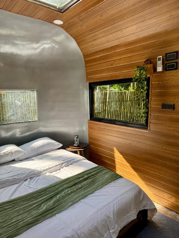 a bedroom with a bed and a window at Anora Eco-Resort Siquijor in Lazi