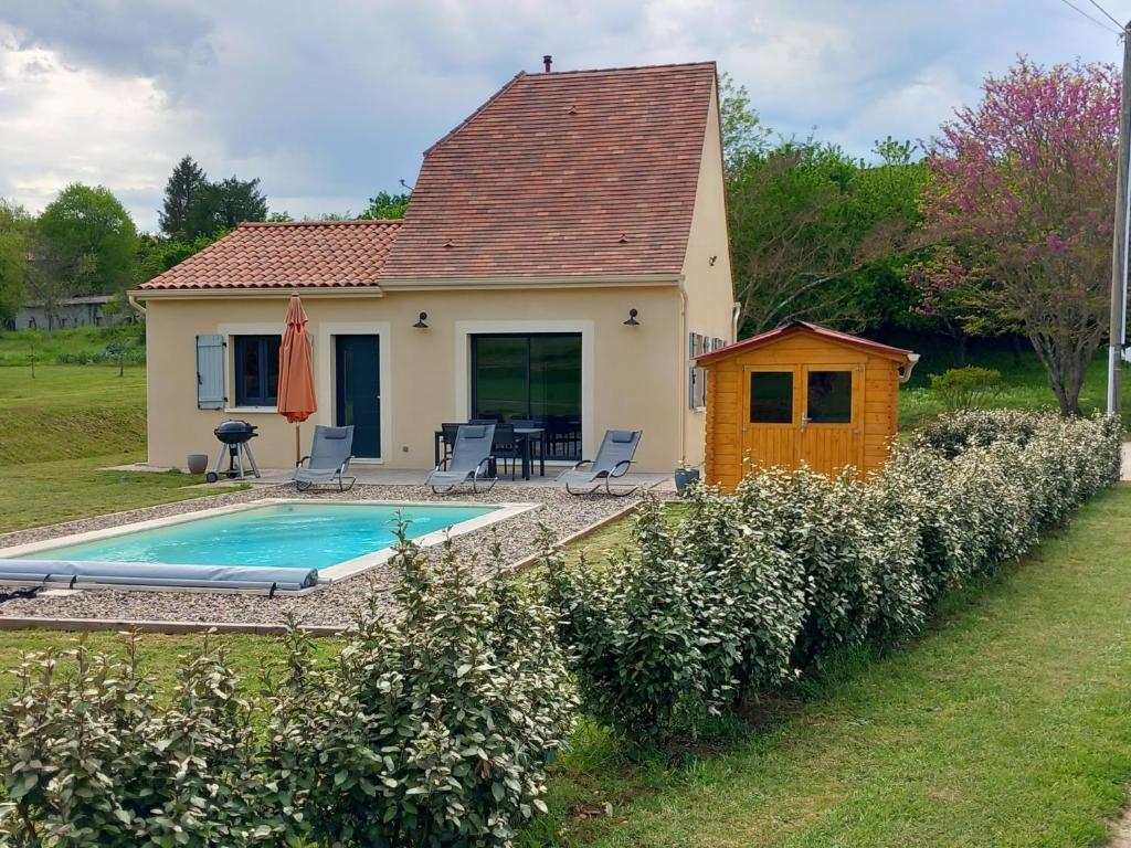 a small house with a swimming pool in front of it at Location proche Sarlat in Prats-de-Carlux