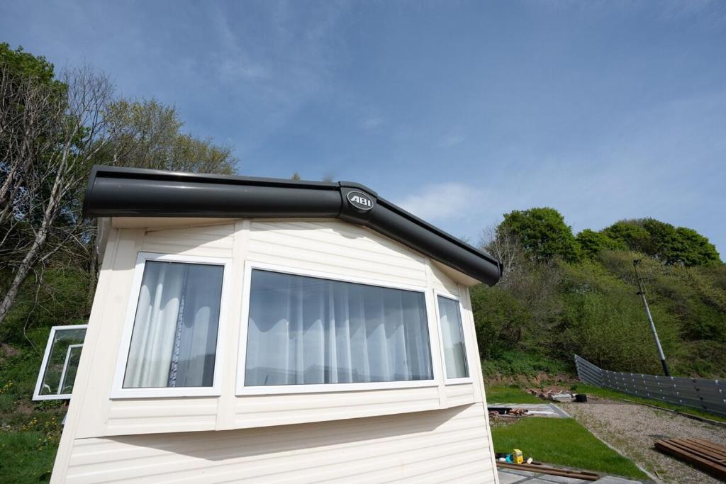 a house with a large window on the side of it at Brechin Getaway the rowan 2 bedroom static in Angus