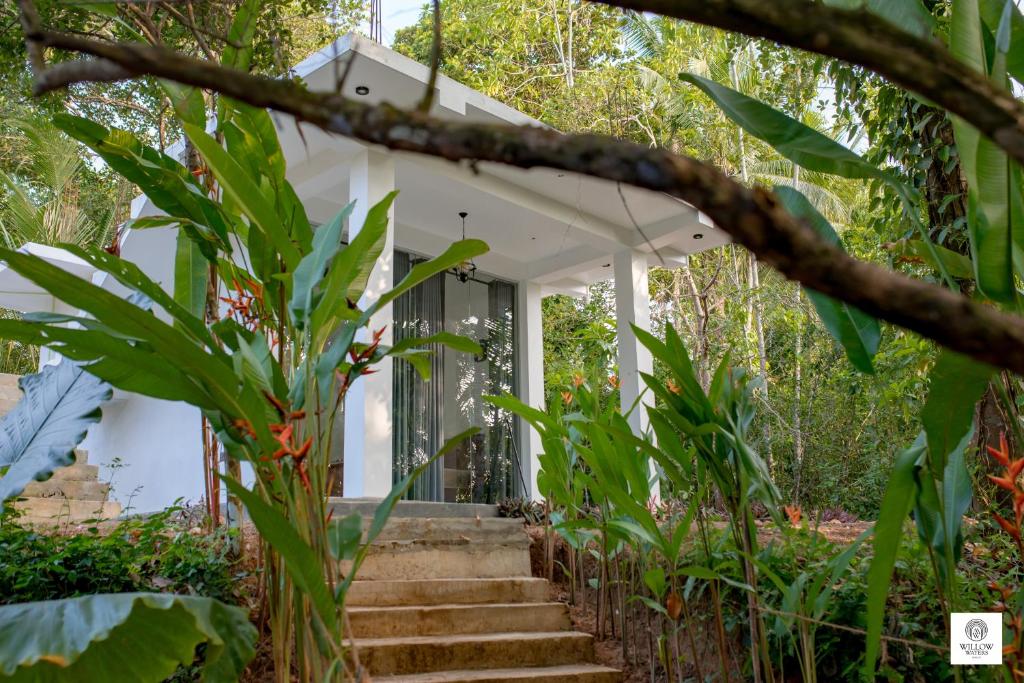 a white house with stairs leading up to it at Willow Waters in Galle
