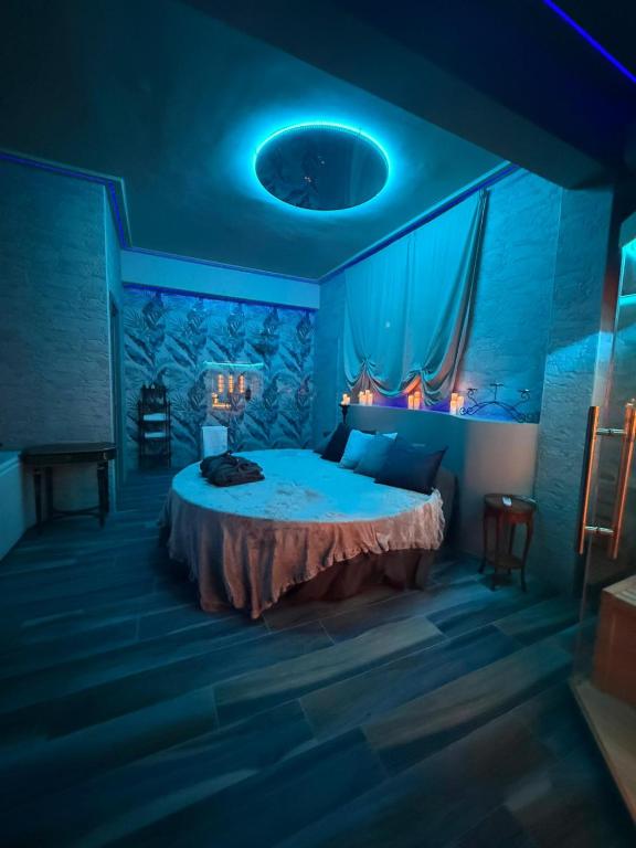 a bedroom with a large bed with blue lighting at Tecaia Secret Luxury Suite in Formia
