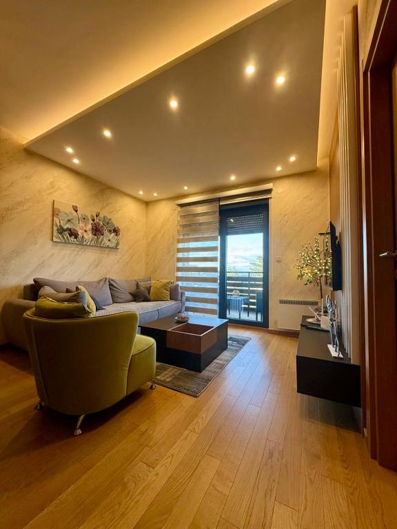 a living room with a couch and a table at BalkanHill2 S37 Pekovic green in Zlatibor