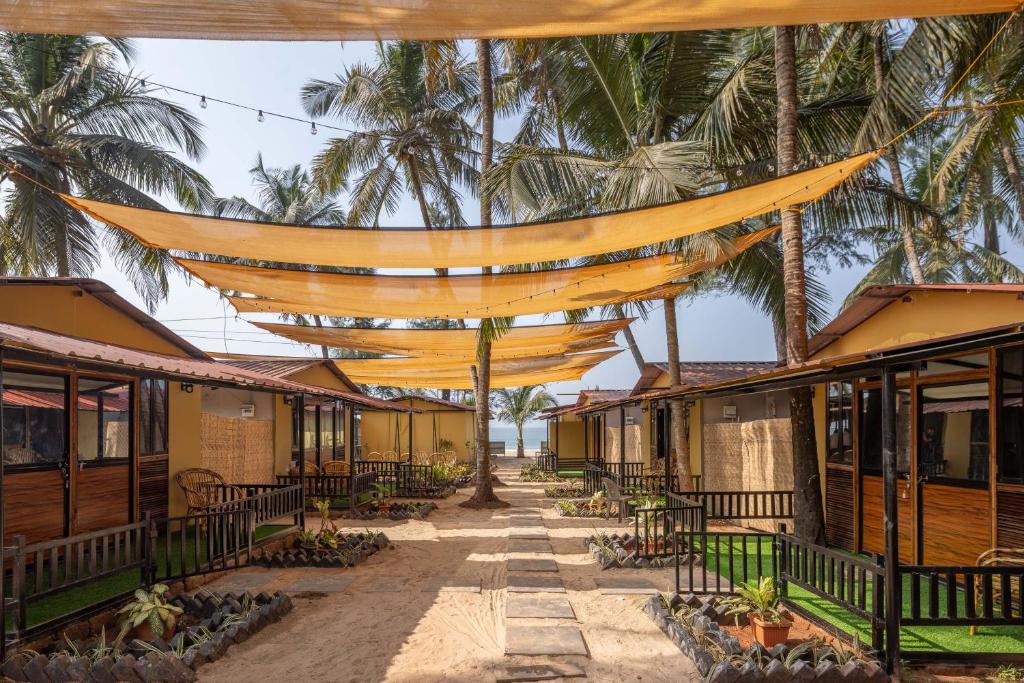 een rij huizen met oranje netten eroverheen. bij Deepiksha Beach Resort Talpona in Magdāl