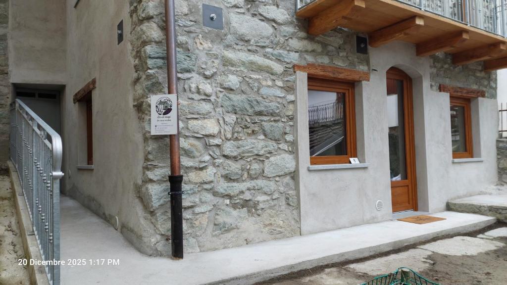 een gebouw met een uithangbord aan de zijkant bij La cò viéyi - La casa vecchia in Ala di Stura