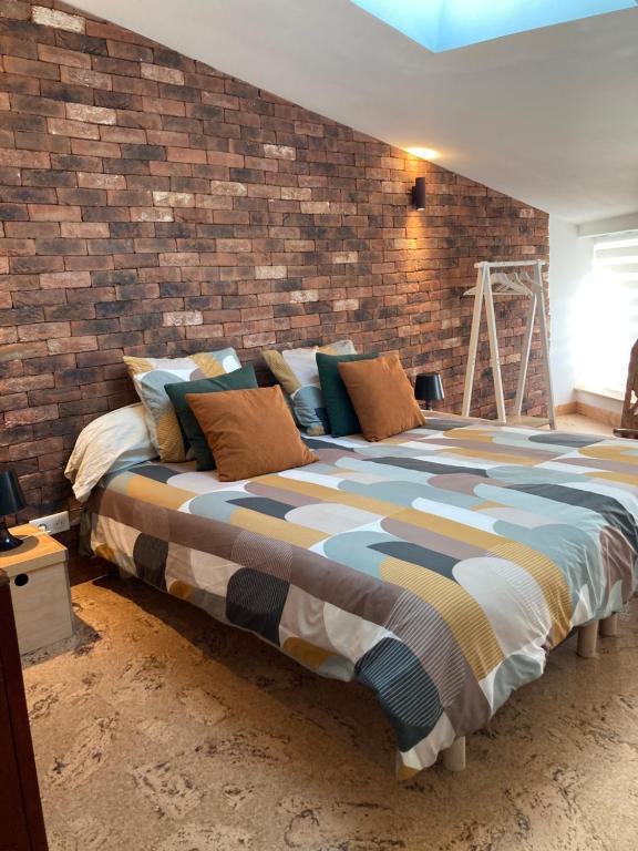 En eller flere senge i et værelse på L'atelier du faubourg