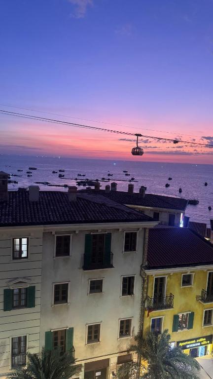 a building with a view of the ocean at sunset at Moonlight Hotel Phu Quoc in Phú Quốc