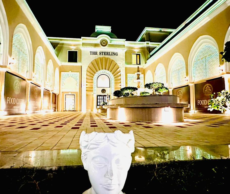 a building with a statue of a head in the middle at The Sterling Resort in Bhawānīgarh