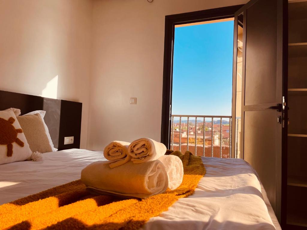 a bedroom with a bed with towels on it at ZyonFamily in Ouarzazate