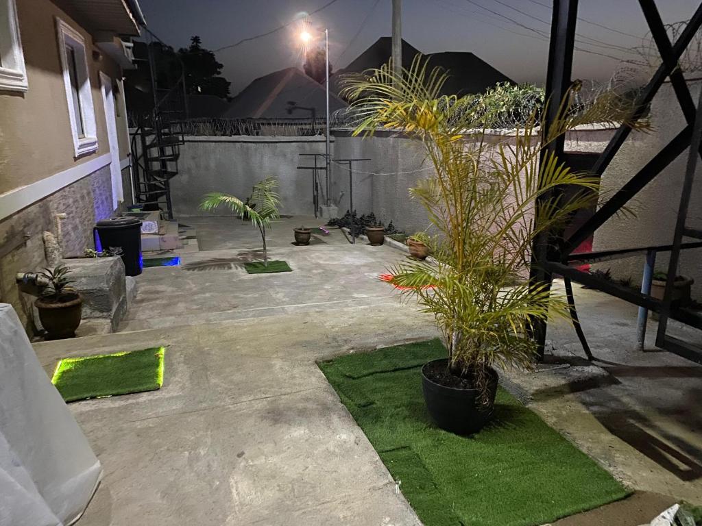 a patio with potted plants and a fence at The Flamingo 2 in Jos