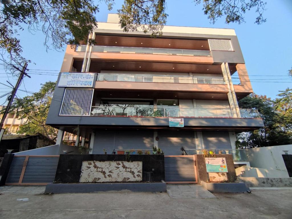 a tall building with a fence in front of it at RT RESIDENCY HOTEL and LODGE in Nandurbār