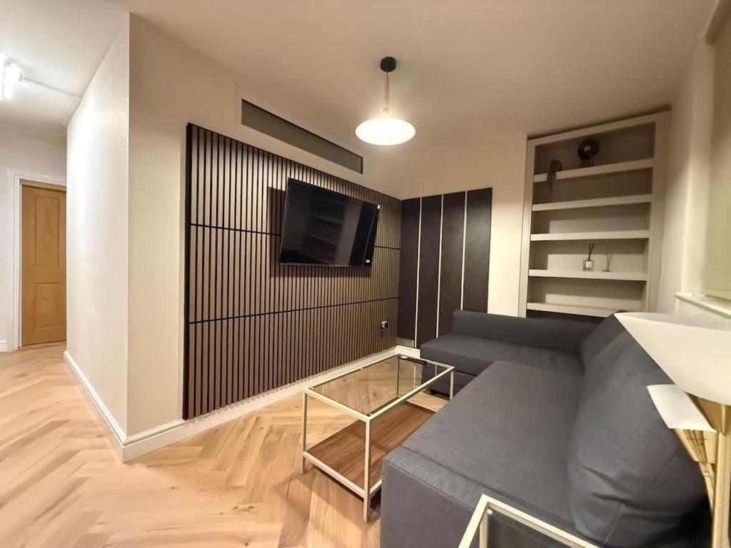 a living room with a couch and a flat screen tv at Fantastic Two Bed Flat In Paddington Central London Zone 1 in London