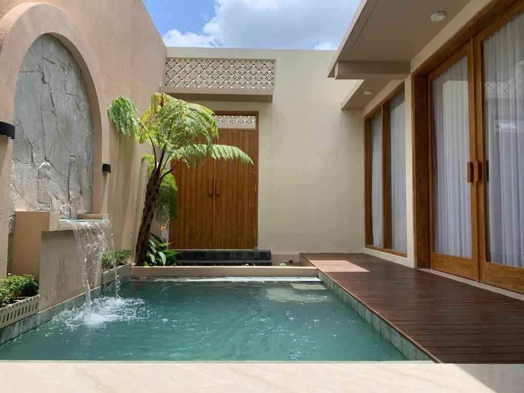a swimming pool in the middle of a house at Kamaya Villa Jogja in Ngaglik