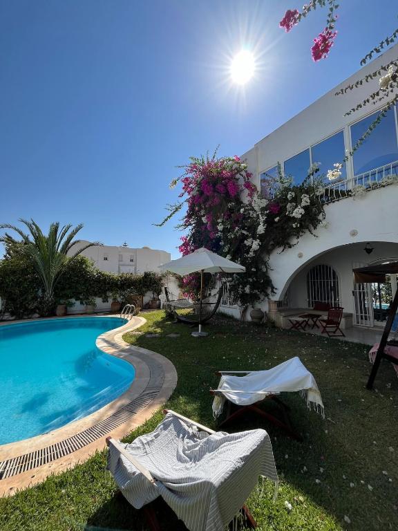 a house with a swimming pool next to a building at South Hammamet Pool Villa in Hammamet Sud