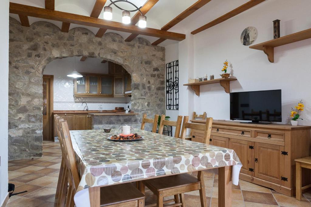 a kitchen and dining room with a table and chairs at Casa rural BUSEO in Chera
