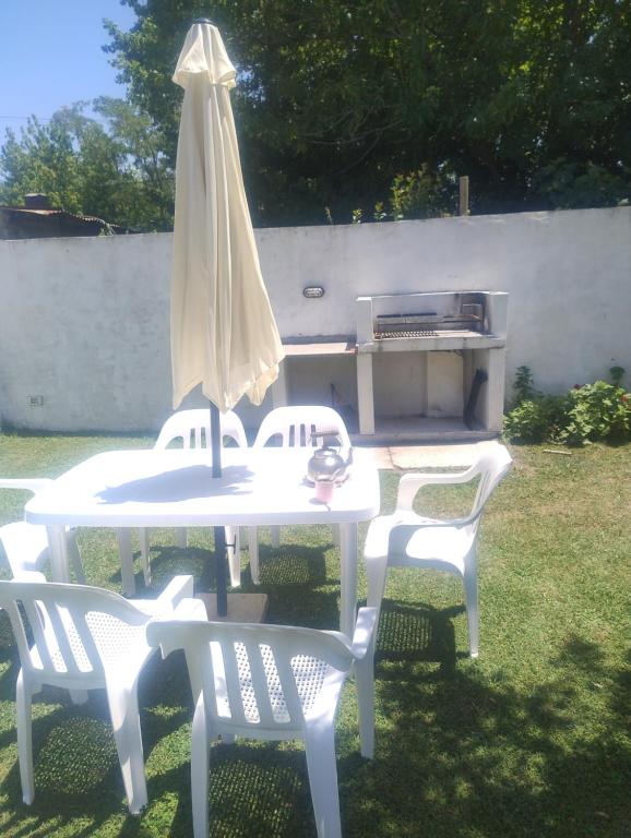 een witte tafel met twee stoelen en een parasol bij Los Abuelos in Dolores