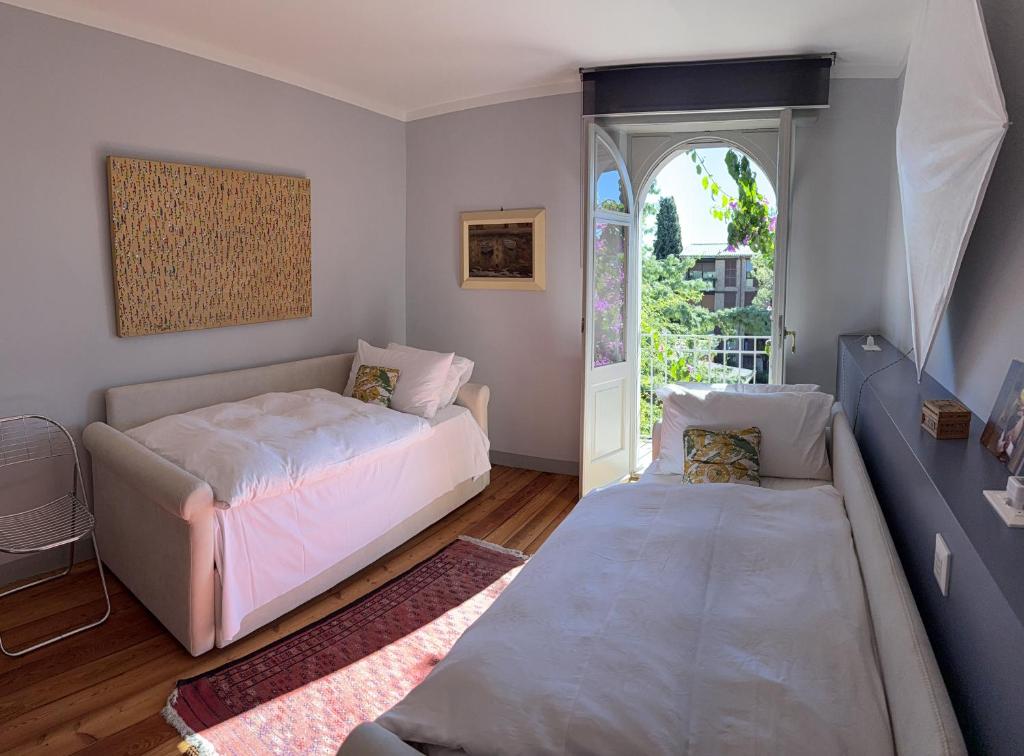 En eller flere senge i et værelse på Villa Lucia mit Pool in Gardone Riviera, Gardasee