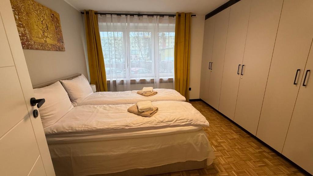 a bedroom with a bed with two towels on it at W Centrum in Piła