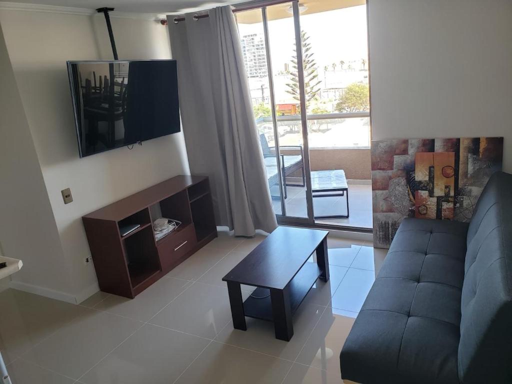 a living room with a couch and a table at Zapahuira in Arica