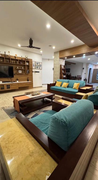 a large living room with couches and tables at Krishnamadom in Kollam