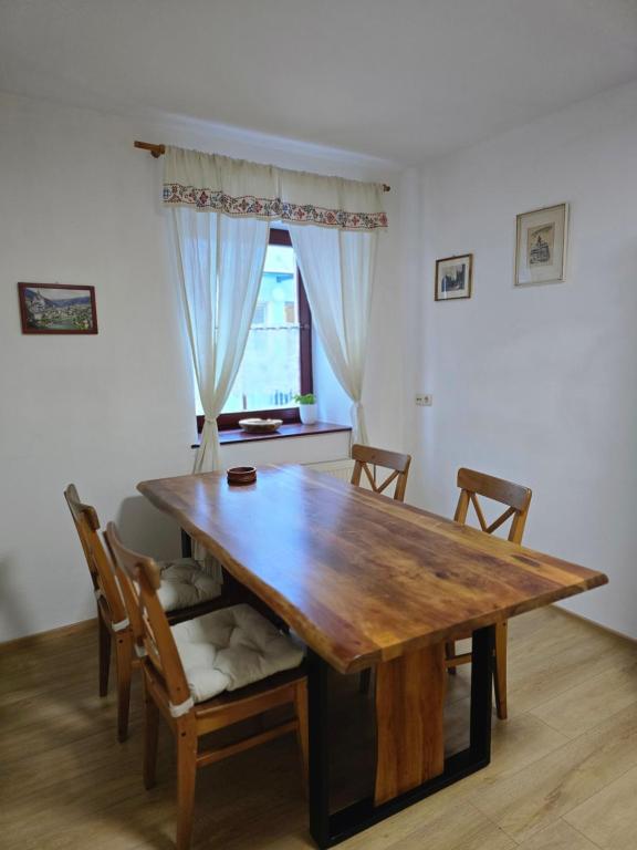 a dining room with a wooden table and chairs at Sager Haus in Murau