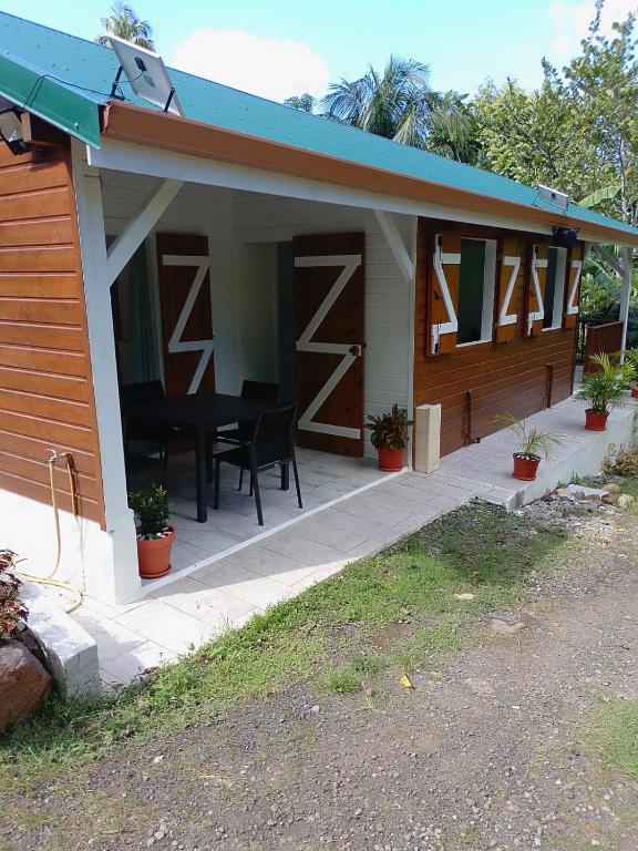 a house with a porch with a black piano on it at Brada Gites2 in Deshaies