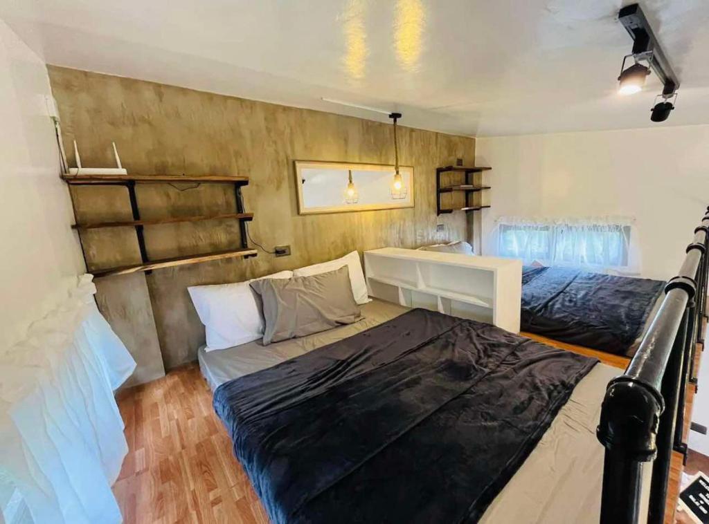 a small room with two beds and a desk at Balai Halang in Palavit