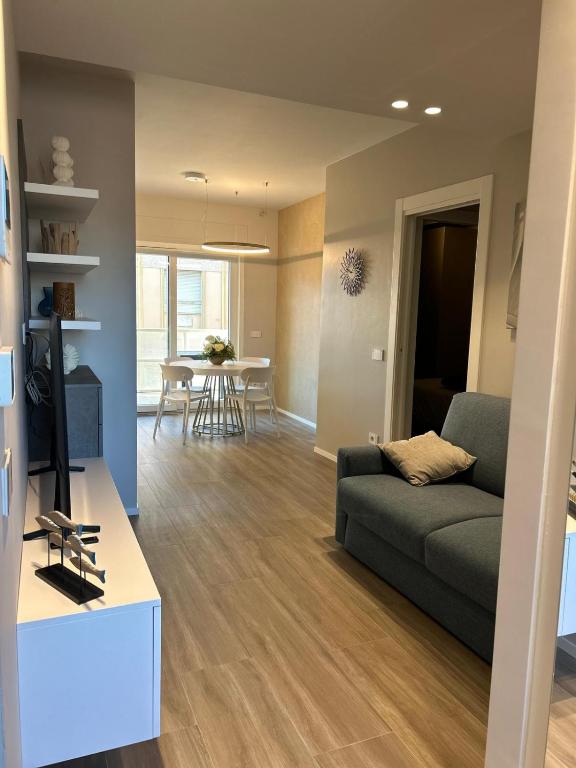 a living room with a couch and a table at Brezza di mare home con garage in Civitanova Marche