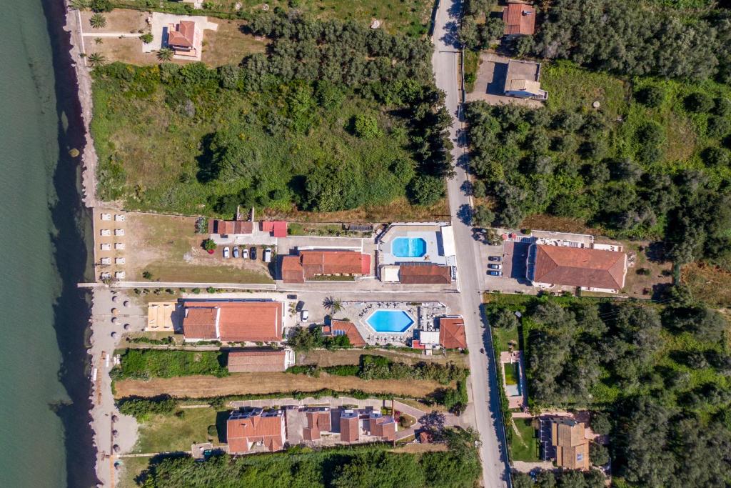 an aerial view of a house with a road at Saint Peter Bay Aparthotel in Kavos