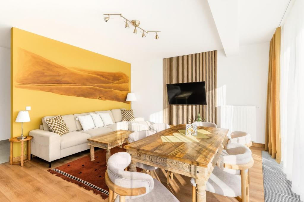 a living room with a table and a couch at Apartamenty Oaza Superior Zakopane in Zakopane