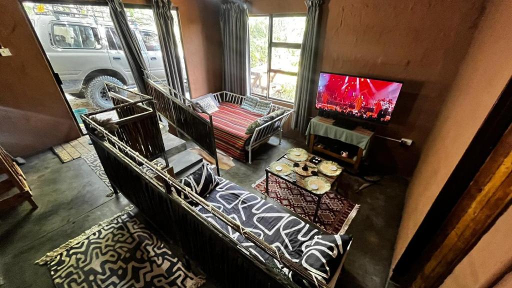an overhead view of a living room with a tv and a couch at Zoko cottage in Maun