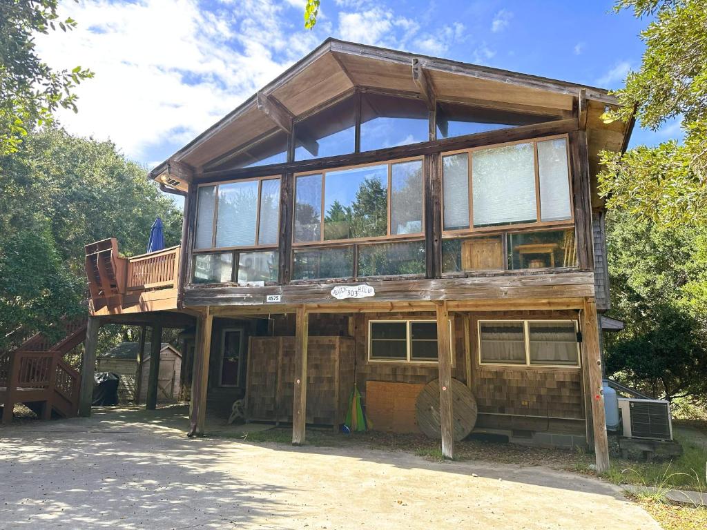 a wooden house with glass windows on top of it at SS303- Duck Hill in Southern Shores