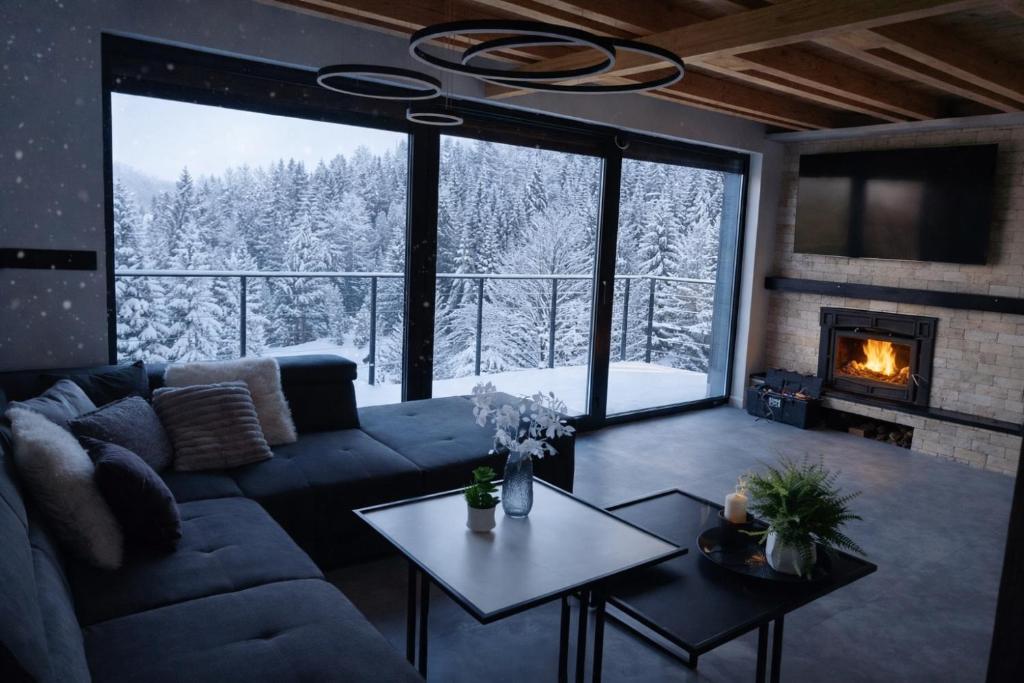 a living room with a couch and a fireplace at Top Hill Vista in Sekulić 