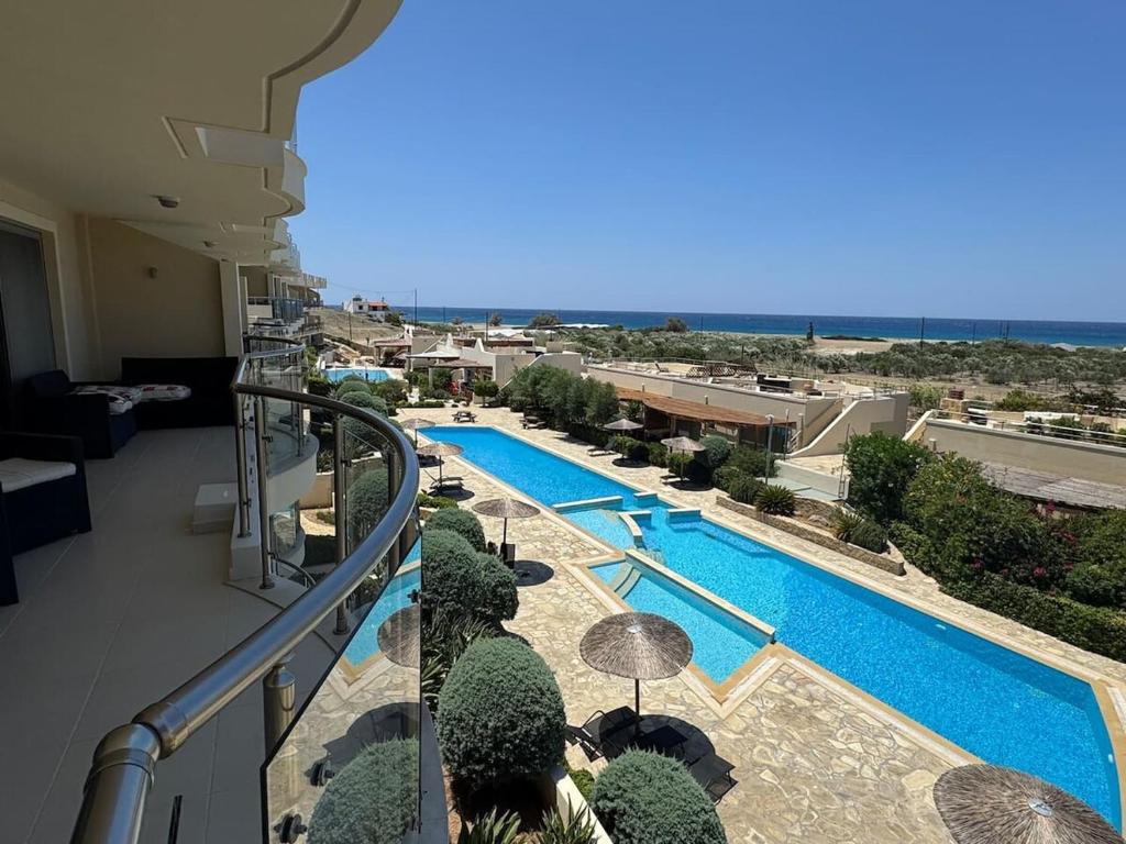 a balcony with a view of a swimming pool at Luxury Lagada Loft Sea Views in Pilalímata
