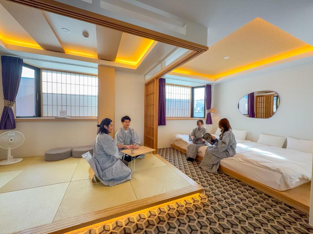 a group of people sitting in a hotel room at Hotel Imagine Kyoto in Kyoto