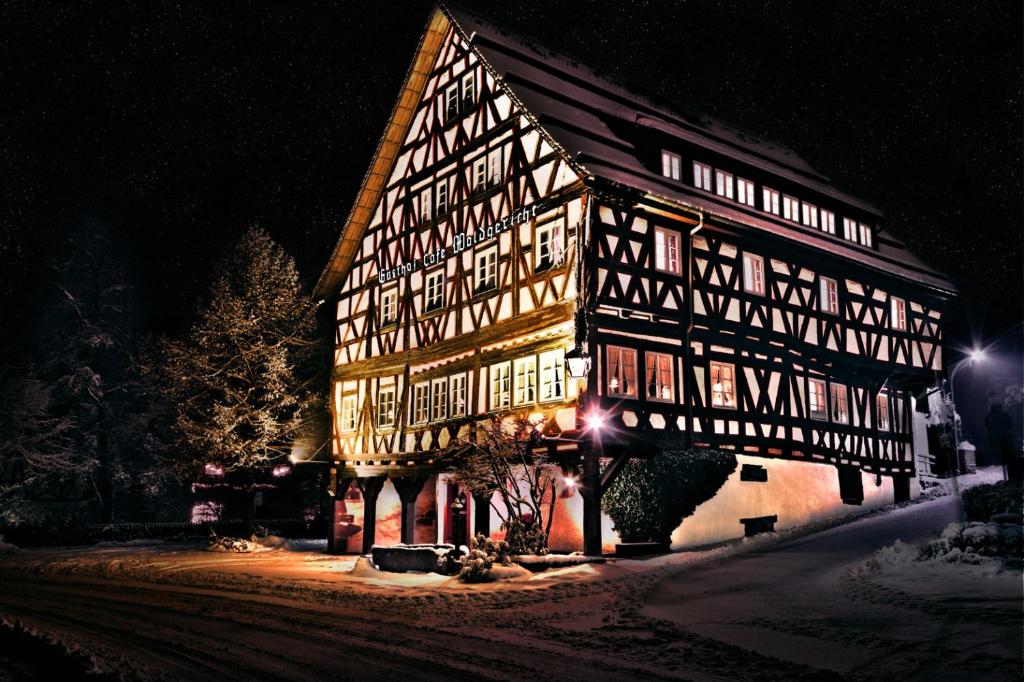 een groot gebouw met 's nachts verlichting bij Gasthof Waldgericht in Dornstetten