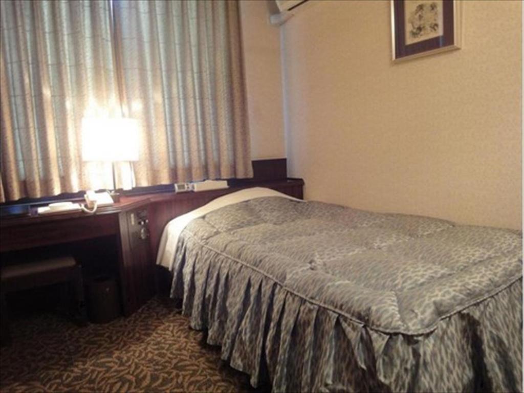 Postel nebo postele na pokoji v ubytování Hotel CROWN HILLS MIYOSHI