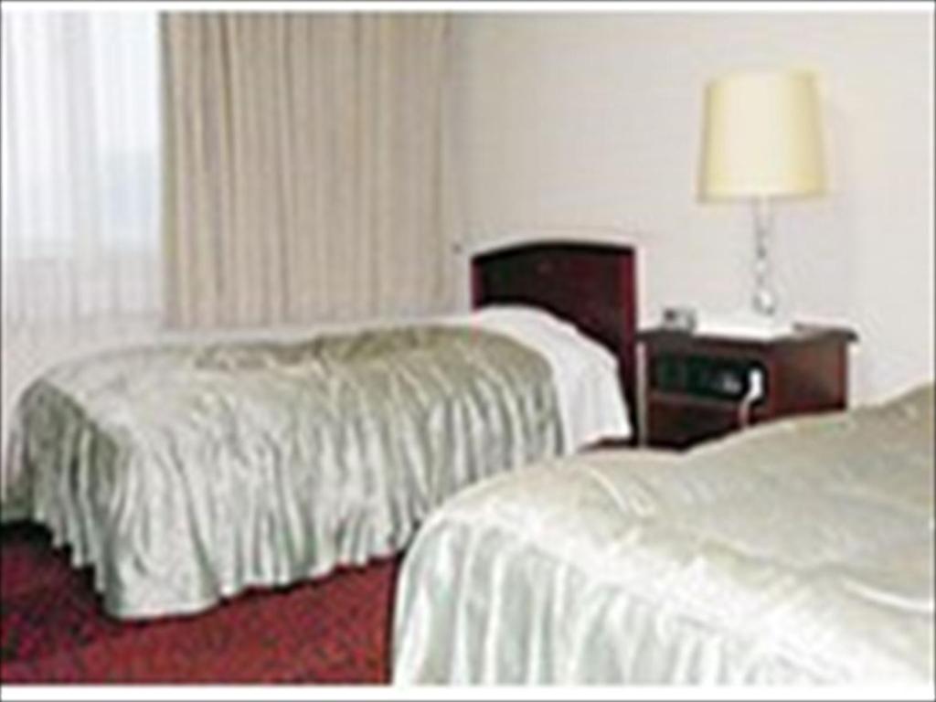 Postel nebo postele na pokoji v ubytování Hotel CROWN HILLS MIYOSHI